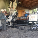 Healy - Inserting grout pipes in tight quarters to lift building.