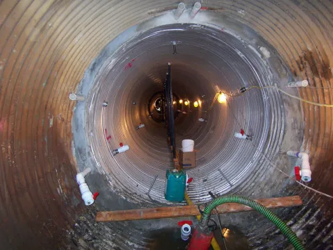 Juneau - Sliplined aluminum 7' dia pipe x 140' long, inside of an 8' host pipe. The bulkhead is in place with injection and drain ports situated for 4 lifts along with  center bracing.