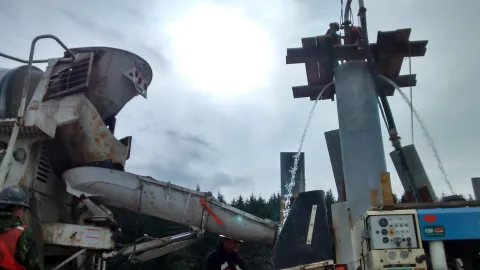 Hoonah- Putz TK70 pumping flowable grout through tremie to fill pilings and float out water.